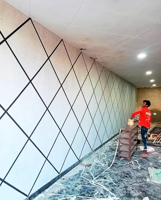 Applicator finishing a long wall with dark diamond lines