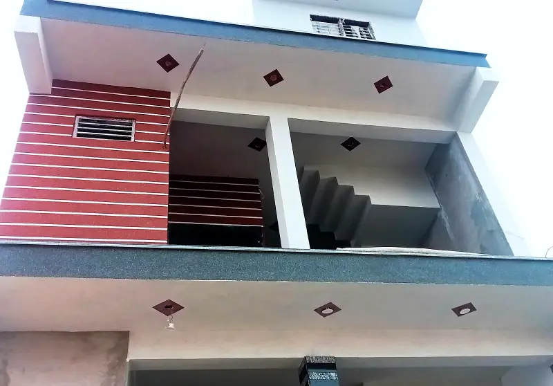 Balcony with a red striped panel and textured soffits