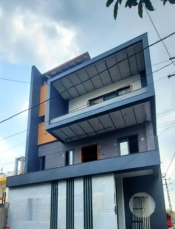 Three-storey modern house front finished in dark grey texture