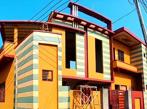 Two-storey house front in orange, green and cream bands