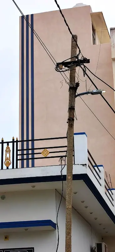 Tall house wall with blue vertical stripes